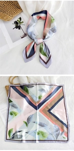 Detail of silk square scarf featuring geometric stripes and tropical leaf patterns