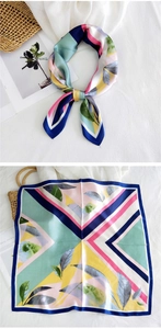 Detail of royal blue and pink silk scarf showing modern geometric patterns and leaf print