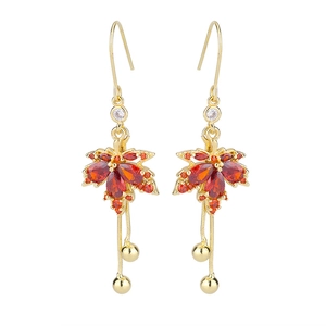 Detailed close-up of red maple leaf earrings with gold snake chains and zircon stones