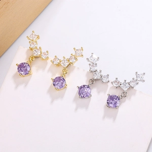 Detailed view of teardrop earrings with luxury zircon stones in gold and silver finish