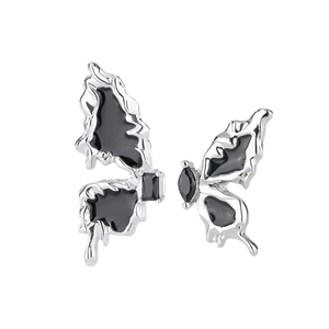 Asymmetric black butterfly stud earrings with silver metal outlines and dark gemstones