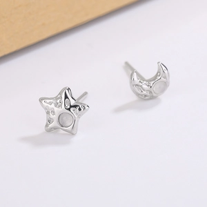 Silver star and moon stud earrings with textured metallic finish and center stone inlay