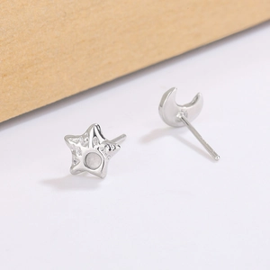 Asymmetric S925 silver star and moon earrings with hammered texture and CZ stone