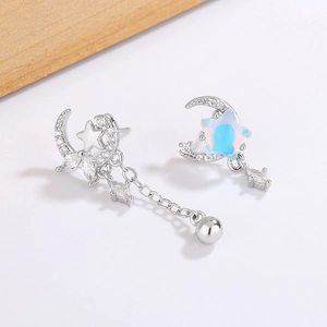 Asymmetric star and moon drop earrings with sparkling crystals and opal finish