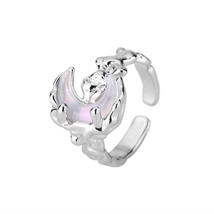 Detailed close-up of crescent moon ring with opal stone and lava texture metal