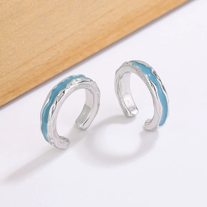 Irregular wavy silver ear clips with sea ice blue enamel inlay for non-pierced ears