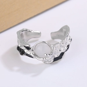 Detail of silver irregular ring with lava texture, moonstone inlay and black enamel