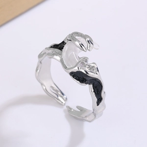 Detail view of liquid metal lava texture ring with moonstone and black enamel accents