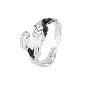 Detail of irregular silver liquid-style open ring with moon element and black enamel