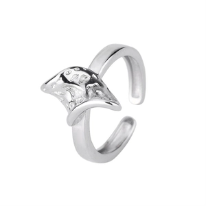 Irregular open ring in silver metal with organic manta ray texture on white background