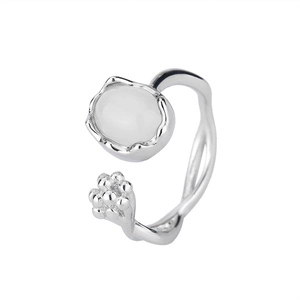 Detail of silver open ring featuring a smooth white moonstone and unique organic curves