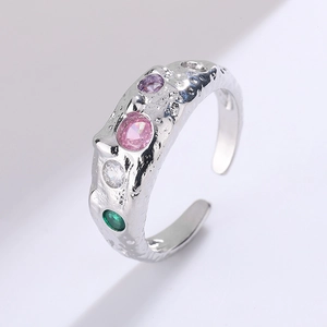 Detail of silver hammer-textured ring featuring four colorful round-cut zircons