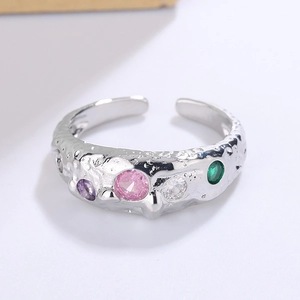 Detail of silver textured lava ring with colorful round zircon stones in a macro view