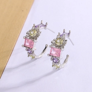 Detail view of silver floral earrings featuring pink, purple and yellow zircons