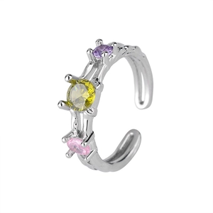 Macro view of irregular silver ring with yellow, purple and pink zircon stones