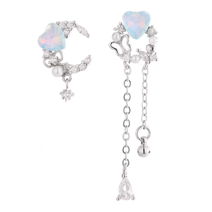 Detailed view of asymmetric heart earrings with crescent moon, pearls and long tassels