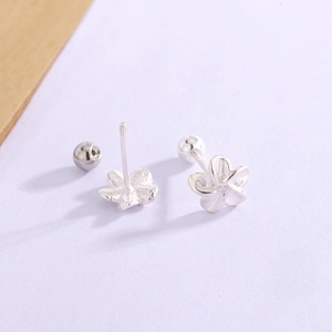 Macro view of 925 silver flower earrings featuring secure screw-back design and zircon