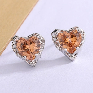 Detail of heart stud earrings with champagne gemstone and vintage silver engraving
