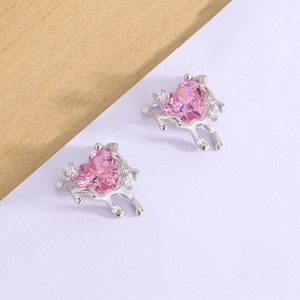Detail of silver lava heart earrings with pink zircon and liquid metal texture
