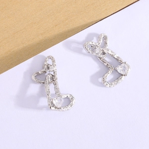 Detail of silver double heart stud earrings with lava texture and sparkling cubic zirconia