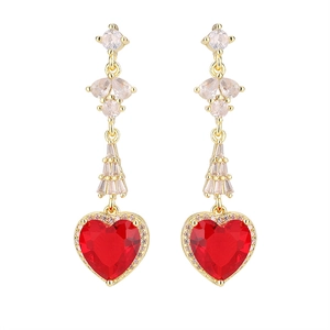 Detail view of red heart zircon earrings with gold settings and clear stones drop