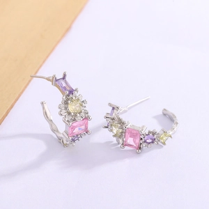 C-shaped silver earrings with colorful zircons and flower design on white background