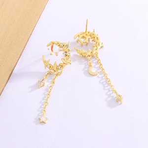 Detail of crescent moon tassel earrings with opal-style stones and leaf texture