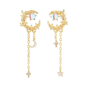 Close-up of crescent moon earrings with long tassels, golden birds, and zircon details