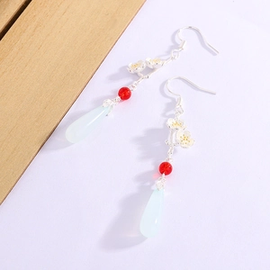 Detail of vintage Chinese style long tassel earrings with white flowers and green drops