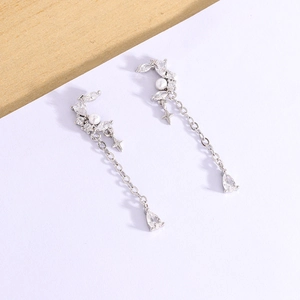 Elegant asymmetrical star and moon long drop earrings with white pearls and sparkling zircons