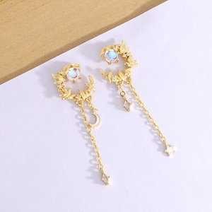 Elegant gold moon and bird tassel earrings with blue stones and shimmering star charms