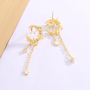 Elegant gold crescent moon and bird tassel earrings with white pearls on violet background