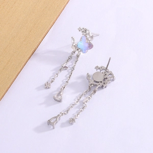 Detail of silver tassel earrings with iridescent butterfly and drop zircon accents