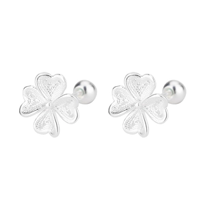 Close-up of silver four-leaf clover stud earrings with hollow filigree and screw ball back