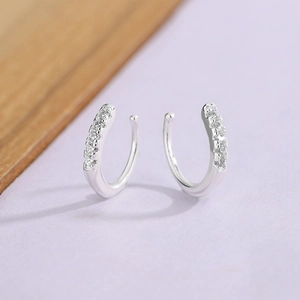 Macro detail of silver non-pierced ear cuffs with pavé-set round cubic zirconia stones