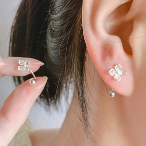Minimalist S925 silver hollow clover earrings with screw back design on ear