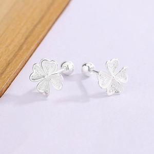 Elegant silver four-leaf clover stud earrings with textured petals and screw back design
