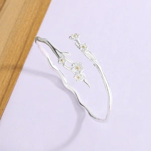 Elegant jasmine silver bangle with cherry blossom design and natural branch texture