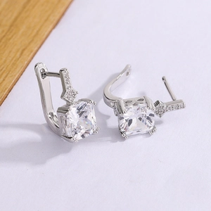 Macro shot of silver lever back earrings featuring square-cut zircon and micro-pave crystals