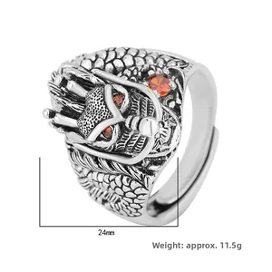 Macro view of vintage silver dragon ring with 24mm width and red gemstone eyes detail