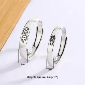 Macro detail of adjustable silver rings with Peace engraving and vintage texture