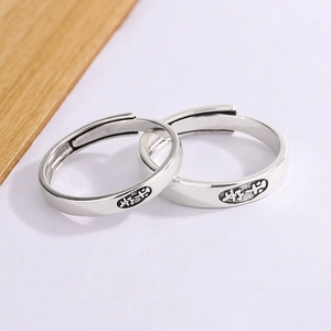 Close-up of vintage silver adjustable rings with engraved Chinese character for safety