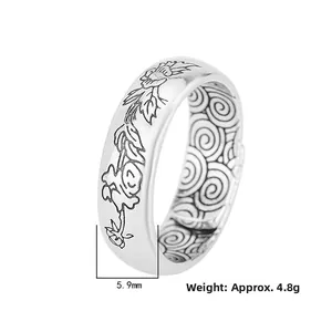 Macro view of a 5.9mm silver lotus ring with embossed flowers and good fortune symbols