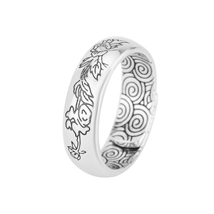 Close-up of vintage Thai silver lotus ring with intricate floral and cloud engravings