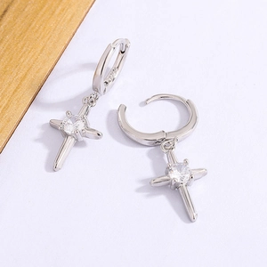 Détail macro du poinçon S925 sur les boucles d'oreilles croix en argent et zircon