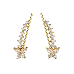 Detailed close-up of gold butterfly crawler earrings with sparkling zircon stones