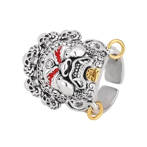 Detail of vintage punk ring featuring intricate deity face and golden skull elements