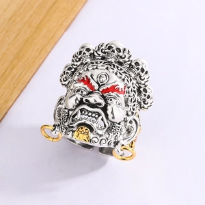 Retro silver Mahakala ring with skull carvings and red eye details in a 45-degree angle