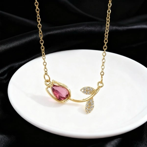 Golden tulip necklace with pink zircon and paved crystals on elegant black silk background