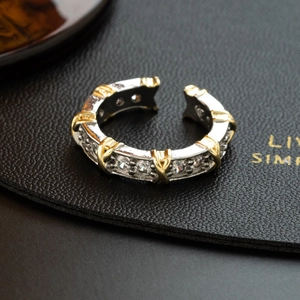 Elegant silver ring with gold X motif and pavé cubic zirconia in a modern open design